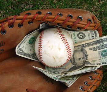 baseball and cash in baseball glove